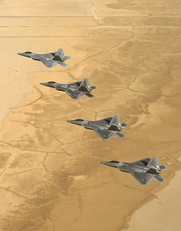 Four F/A-22 Raptors are captured flying a four-ship formation in the skies above Edwards during a recent operational test flight here. (Photo by Kevin Robertson)